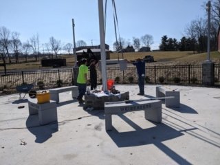 Workers place portions of the monument