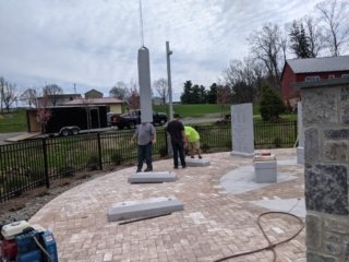 Workers position portions of the monument