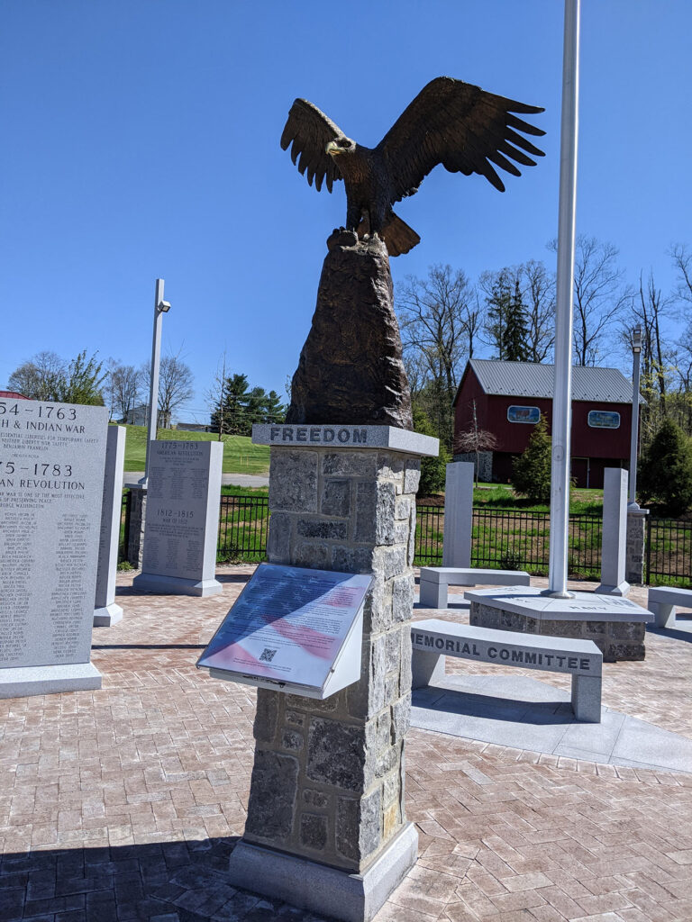A bald eagle statue and the welcome plaque