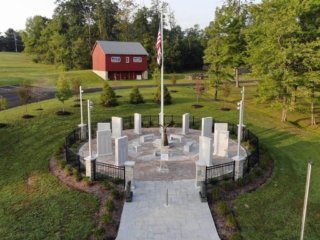 Side view drone photo of memorial in March 2023.